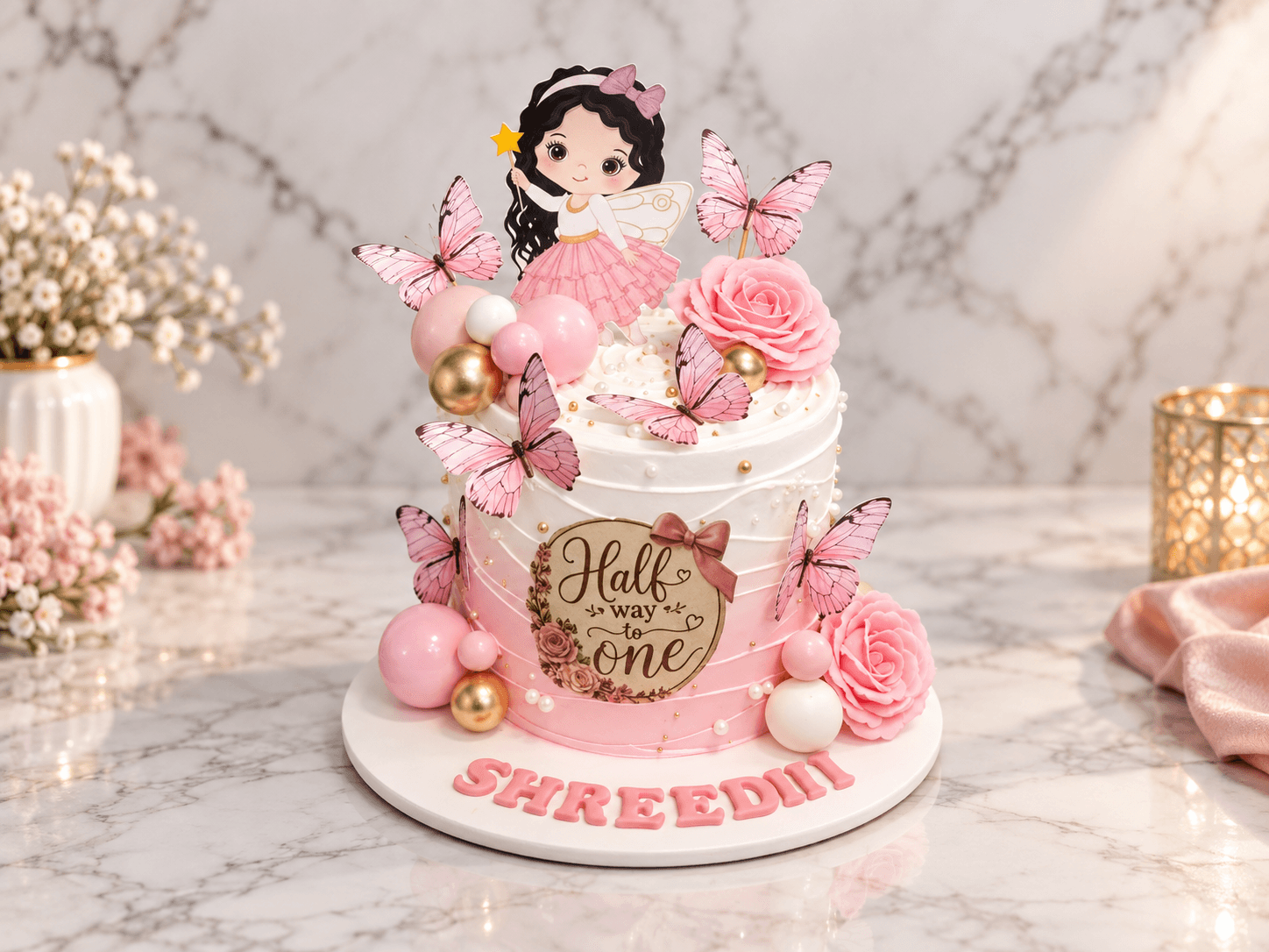 “Half way to one” half-birthday cake with a fairy topper, butterflies and pink roses