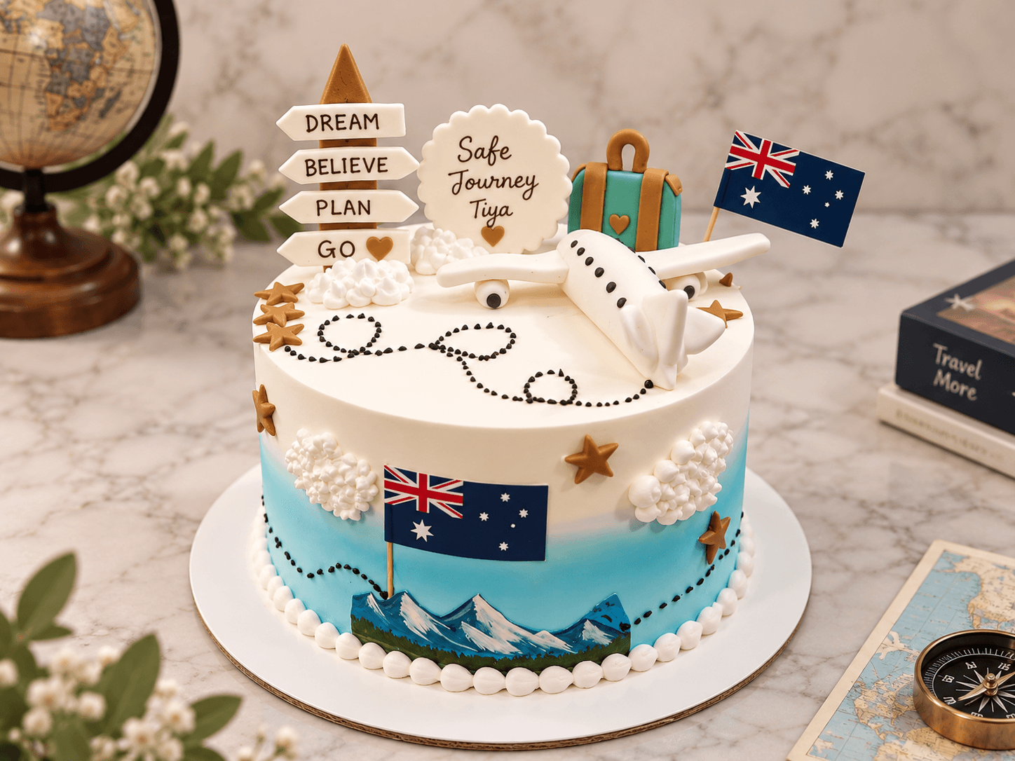 Travel-themed “Safe Journey” farewell cake with an aeroplane, flags and mountains